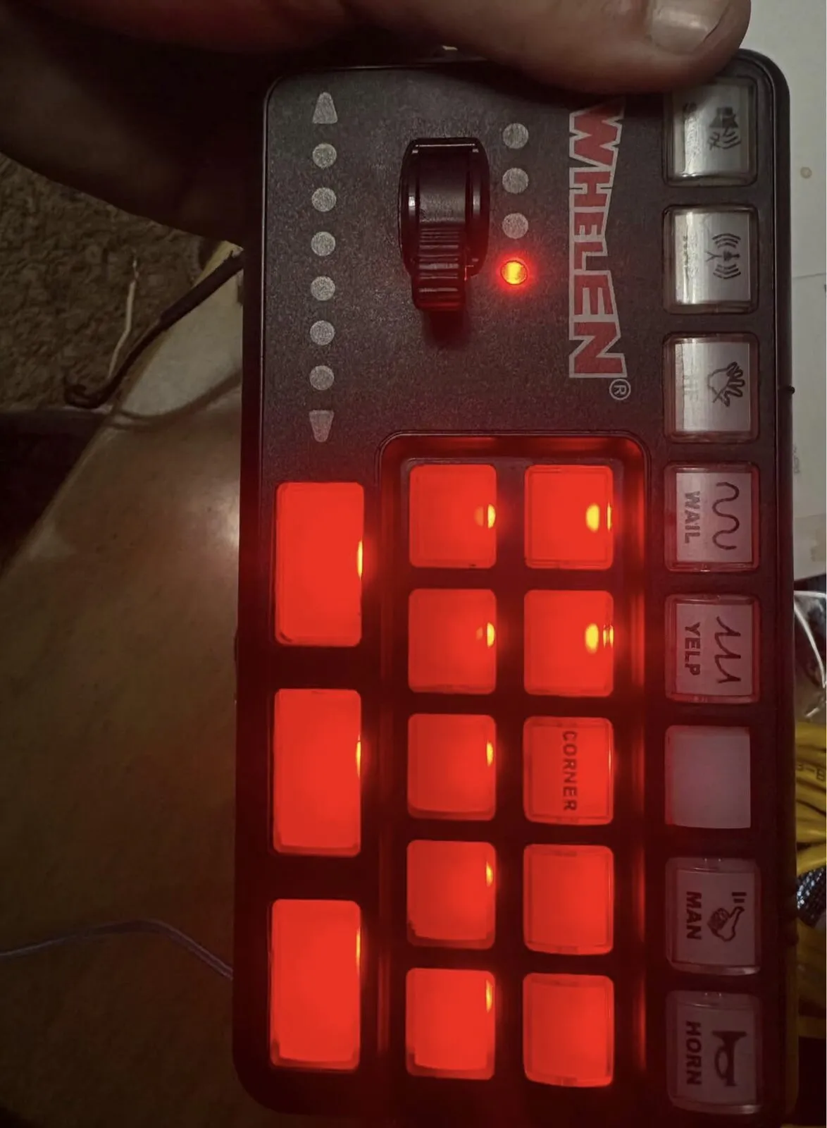 The control head powered up with its buttons backlit red.
